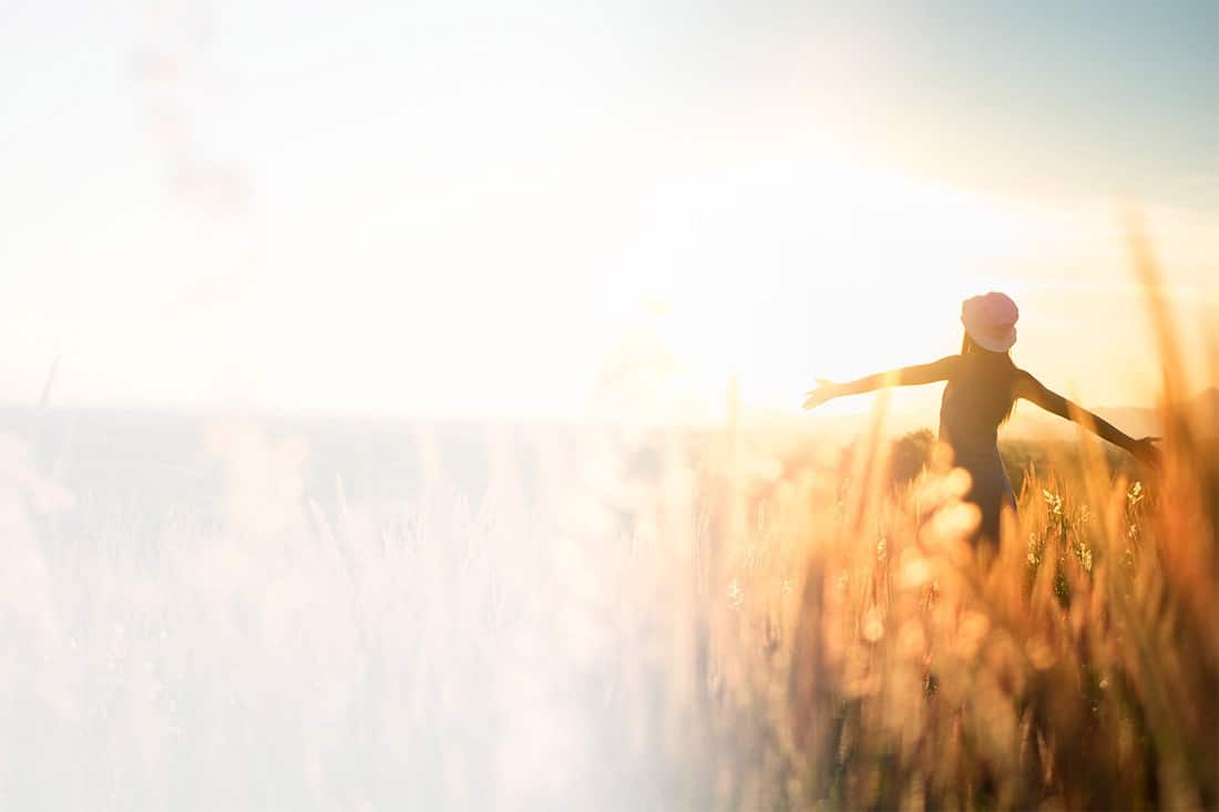 Woman in field on sunny day